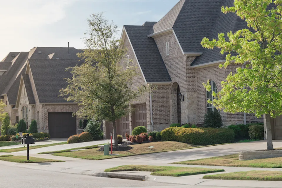 View of brick two-story houses in Dallas suburb